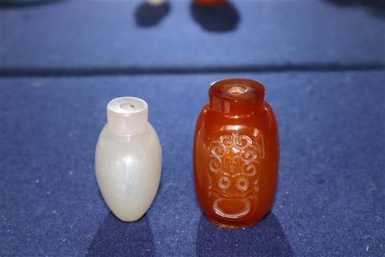 A Chinese agate snuff bottle and an amber glass snuff bottle